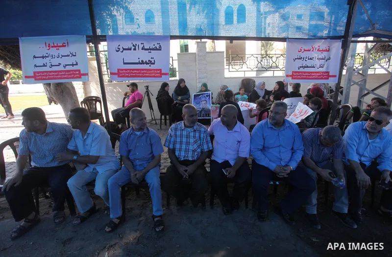 Palestinians take part in a protest to show solidarity with Palestinian prisoners are paid their salaries in Israeli jails in front of the Council of Ministers headquarter in Gaza City, on August 7, 2018. Photo by Mahmou...