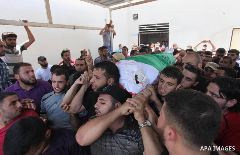Mourners carry the body of Palestinian Hamas militant Abdel-Hafez al-Silawi who was killed in Israeli tank shelling, during his funeral in Jabaliya, northern Gaza Strip, August 7, 2018. Israeli forces killed two militant...