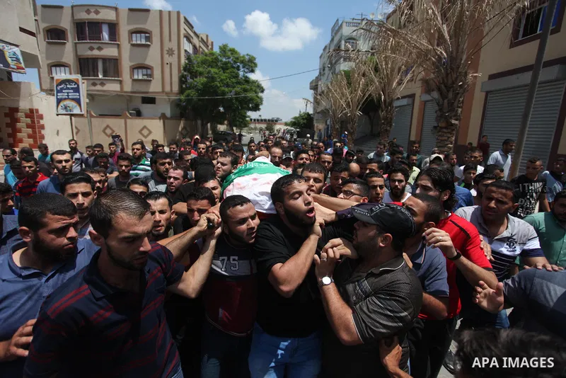 Mourners carry the body of Palestinian Hamas militant Abdel-Hafez al-Silawi who was killed in Israeli tank shelling, during his funeral in Jabaliya, northern Gaza Strip, August 7, 2018. Israeli forces killed two militant...