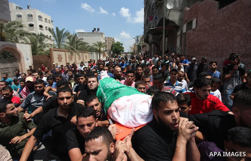 Mourners carry the body of Palestinian Hamas militant Abdel-Hafez al-Silawi who was killed in Israeli tank shelling, during his funeral in Jabaliya, northern Gaza Strip, August 7, 2018. Israeli forces killed two militant...