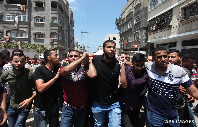 Mourners carry the body of Palestinian Hamas militant Abdel-Hafez al-Silawi who was killed in Israeli tank shelling, during his funeral in Jabaliya, northern Gaza Strip, August 7, 2018. Israeli forces killed two militant...