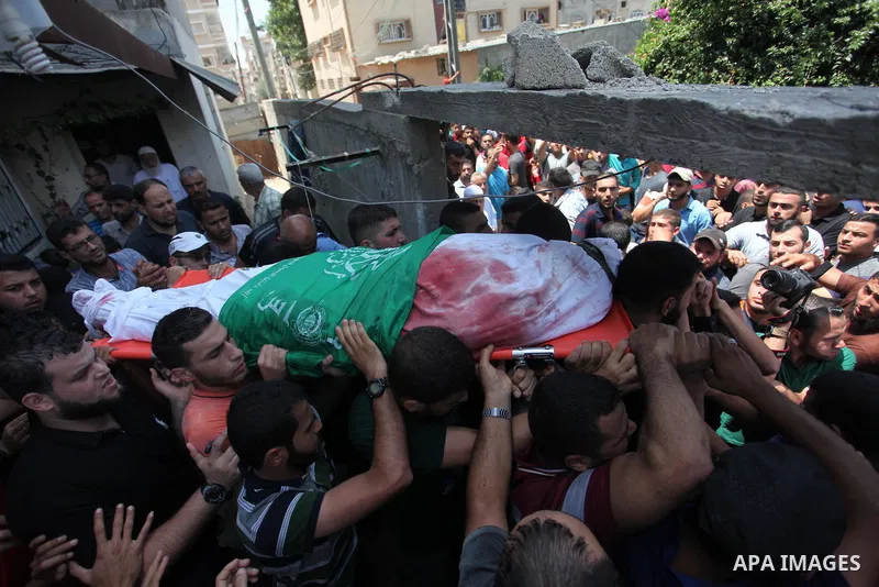 Mourners carry the body of Palestinian Hamas militant Abdel-Hafez al-Silawi who was killed in Israeli tank shelling, during his funeral in Jabaliya, northern Gaza Strip, August 7, 2018. Israeli forces killed two militant...
