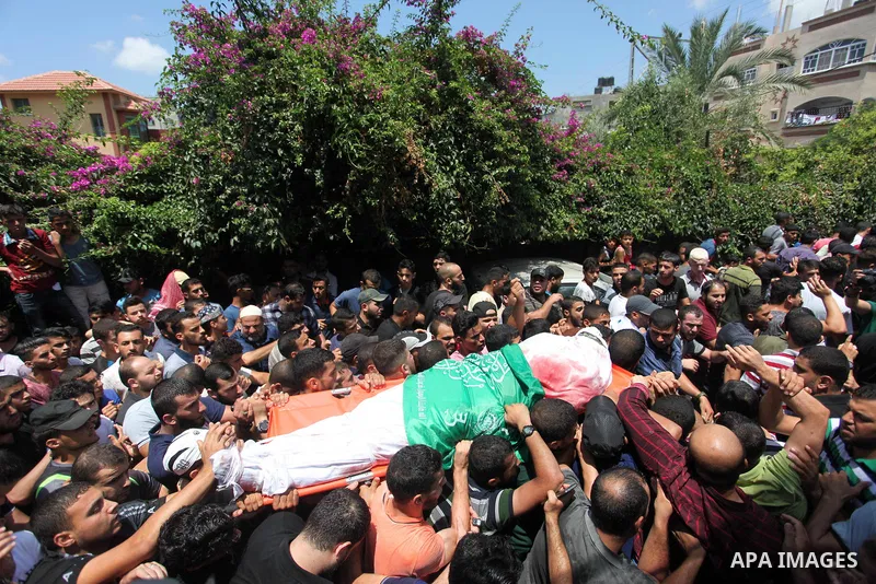 Mourners carry the body of Palestinian Hamas militant Abdel-Hafez al-Silawi who was killed in Israeli tank shelling, during his funeral in Jabaliya, northern Gaza Strip, August 7, 2018. Israeli forces killed two militant...