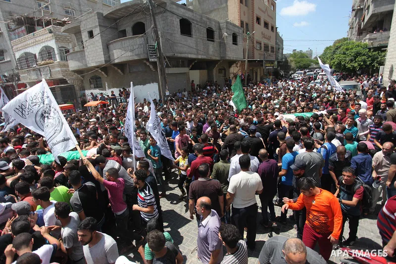 Mourners carry the body of Palestinian Hamas militant Abdel-Hafez al-Silawi who was killed in Israeli tank shelling, during his funeral in Jabaliya, northern Gaza Strip, August 7, 2018. Israeli forces killed two militant...