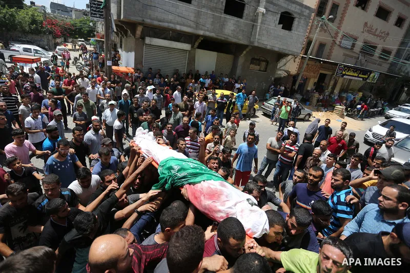 Mourners carry the body of Palestinian Hamas militant Ahmad Murjan who was killed in Israeli tank shelling, during his funeral in Jabaliya, northern Gaza Strip, August 7, 2018. Israeli forces killed two militants of Hama...