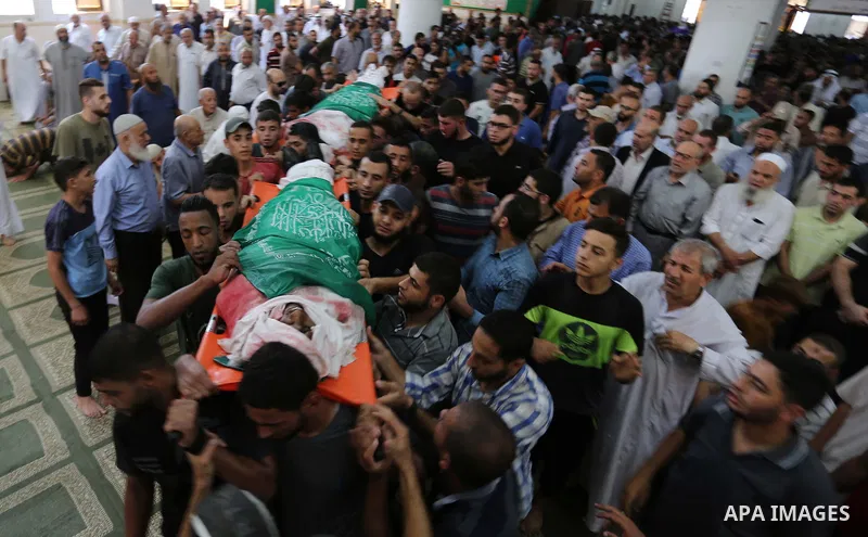 Mourners carry the body of Palestinian Hamas militant Ahmad Murjan who was killed in Israeli tank shelling, during his funeral in Jabaliya, northern Gaza Strip, August 7, 2018. Israeli forces killed two militants of Hama...