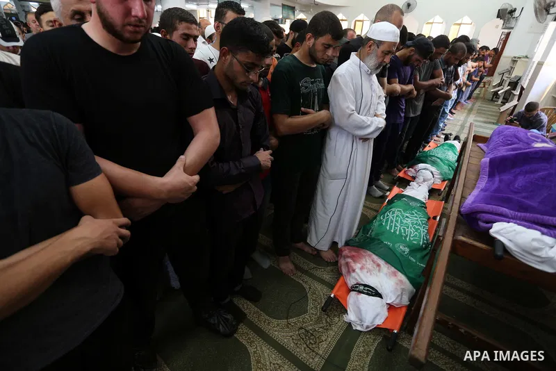 Palestinians pray over the bodies of two Hamas militant Ahmad Murjan and Abdel-Hafez al-Silawi who were killed in Israeli tank shelling, during their funeral in Jabaliya, northern Gaza Strip, August 7, 2018. Israeli forc...