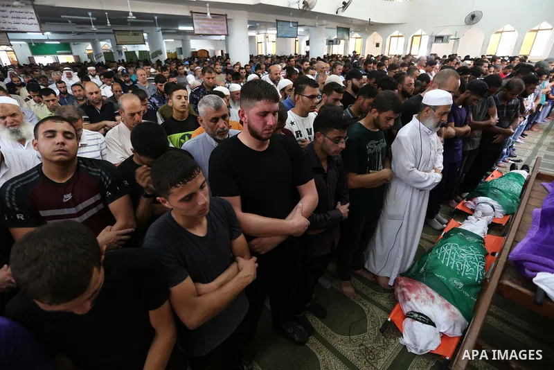Palestinians pray over the bodies of two Hamas militant Ahmad Murjan and Abdel-Hafez al-Silawi who were killed in Israeli tank shelling, during their funeral in Jabaliya, northern Gaza Strip, August 7, 2018. Israeli forc...