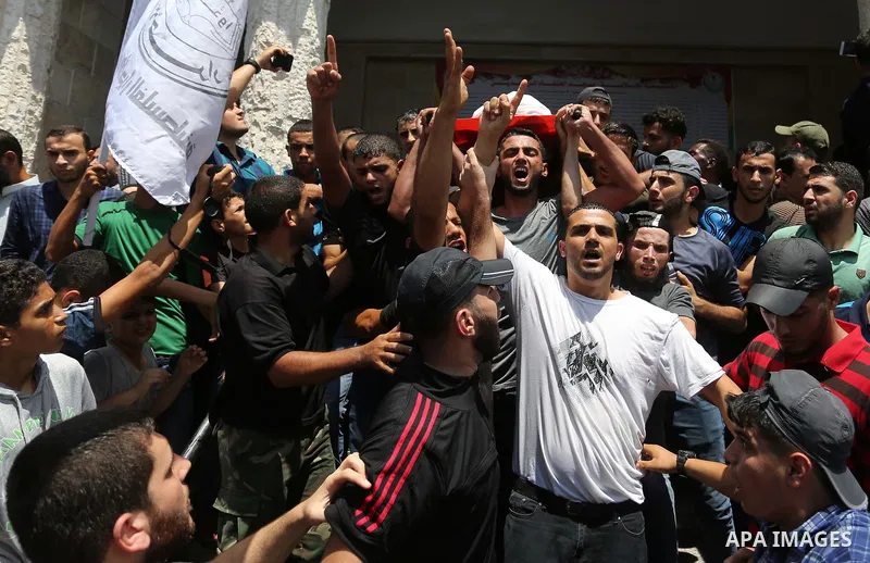 Mourners carry the body of Palestinian Hamas militant Ahmad Murjan who was killed in Israeli tank shelling, during his funeral in Jabaliya, northern Gaza Strip, August 7, 2018. Israeli forces killed two militants of Hama...