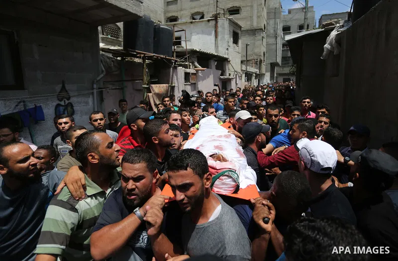 Mourners carry the body of Palestinian Hamas militant Ahmad Murjan who was killed in Israeli tank shelling, during his funeral in Jabaliya, northern Gaza Strip, August 7, 2018. Israeli forces killed two militants of Hama...