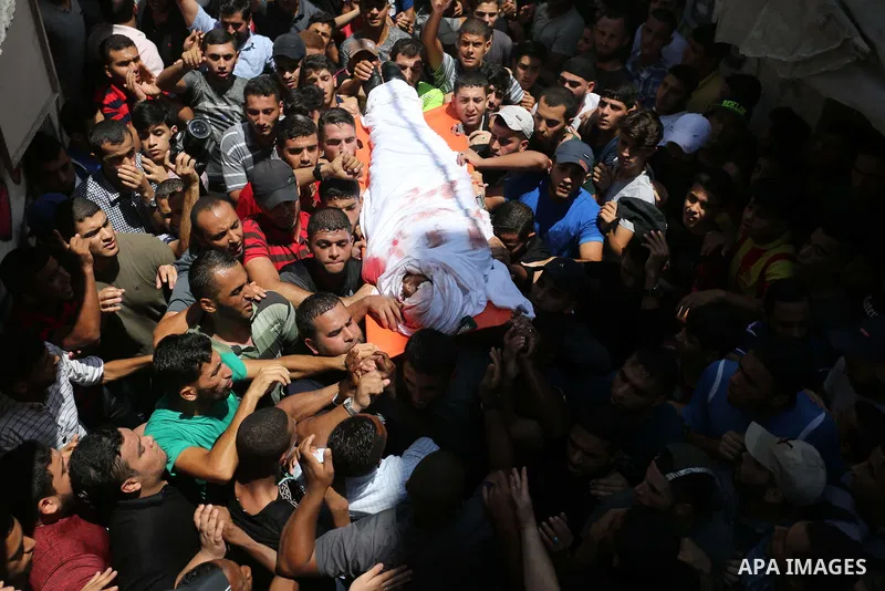Mourners carry the body of Palestinian Hamas militant Ahmad Murjan who was killed in Israeli tank shelling, during his funeral in Jabaliya, northern Gaza Strip, August 7, 2018. Israeli forces killed two militants of Hama...