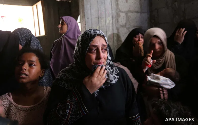 Relatives of Palestinian Hamas militant Ahmad Murjan who was killed in Israeli tank shelling, mourn during his funeral in Jabaliya, northern Gaza Strip, August 7, 2018. Israeli forces killed two militants of Hamas moveme...