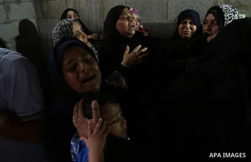 Relatives of Palestinian Hamas militant Ahmad Murjan who was killed in Israeli tank shelling, mourn during his funeral in Jabaliya, northern Gaza Strip, August 7, 2018. Israeli forces killed two militants of Hamas moveme...