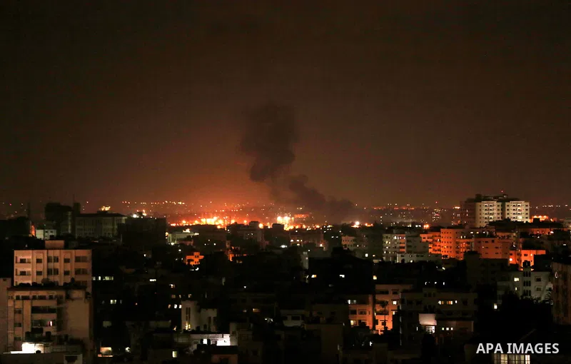 A picture taken on August 8, 2018 shows smoke plumes risisng following an Israeli air strike in Gaza City. Photo by Mahmoud Nasser