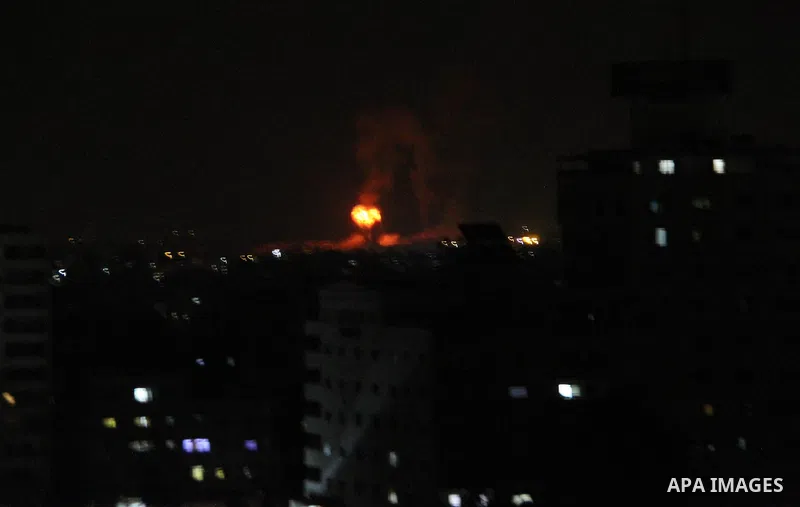 A picture taken on August 9, 2018 shows shows a fireball exploding during Israeli air strikes in Gaza City. Photo by Mahmoud Ajour