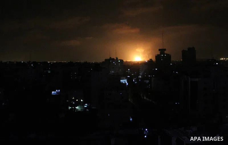 A picture taken on August 9, 2018 shows shows a fireball exploding during Israeli air strikes in Gaza City. Photo by Mahmoud Ajour