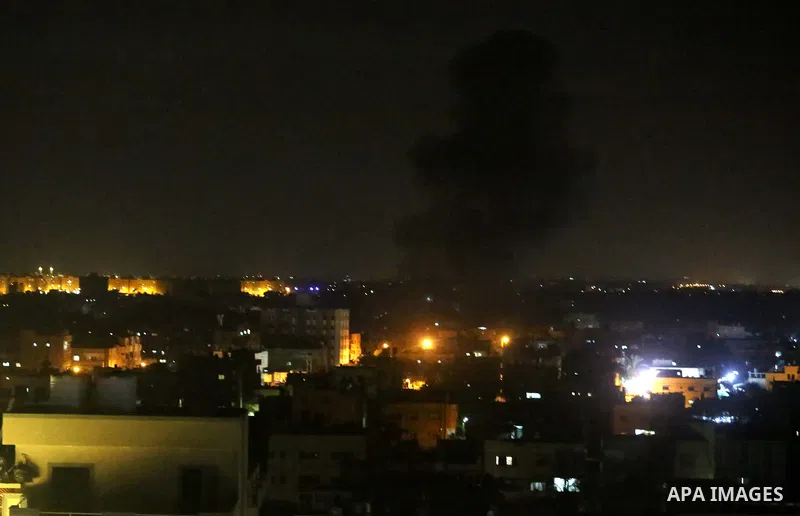 A picture taken on August 8, 2018 shows smoke plumes risisng following an Israeli air strike in Khan Younis in the southern of Gaza strip. Photo by Ashraf Amra