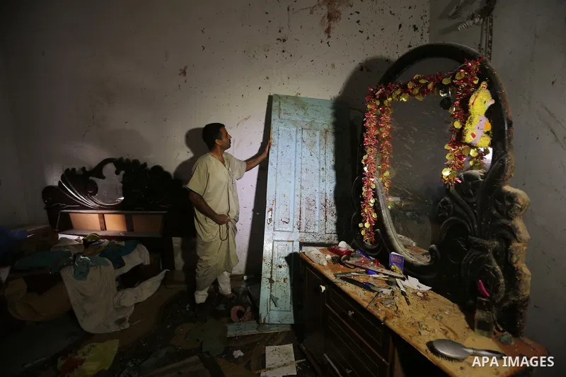 Palestinians inspect a house that was damaged in an Israeli airstrike on Dair al Balah in the center of Gaza Strip on August 9, 2018. Photo by Ashraf Amra