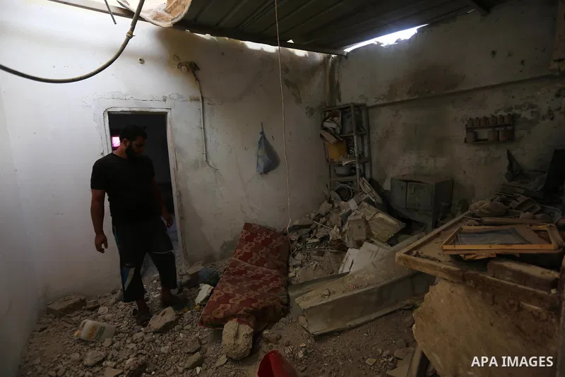 Palestinians inspect a house that was damaged in an Israeli airstrike on Dair al Balah in the center of Gaza Strip on August 9, 2018. Photo by Ashraf Amra