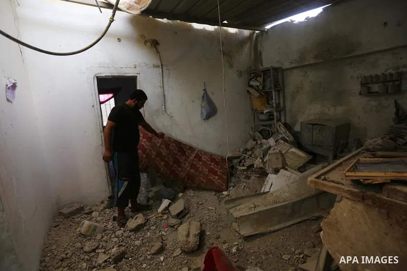 Palestinians inspect a house that was damaged in an Israeli airstrike on Dair al Balah in the center of Gaza Strip on August 9, 2018. Photo by Ashraf Amra