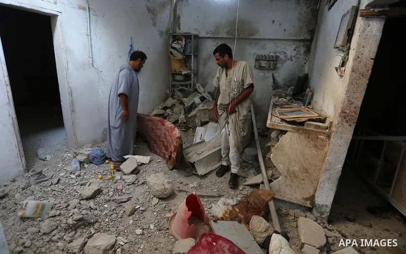 Palestinians inspect a house that was damaged in an Israeli airstrike on Dair al Balah in the center of Gaza Strip on August 9, 2018. Photo by Ashraf Amra