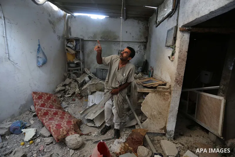 Palestinians inspect a house that was damaged in an Israeli airstrike on Dair al Balah in the center of Gaza Strip on August 9, 2018. Photo by Ashraf Amra