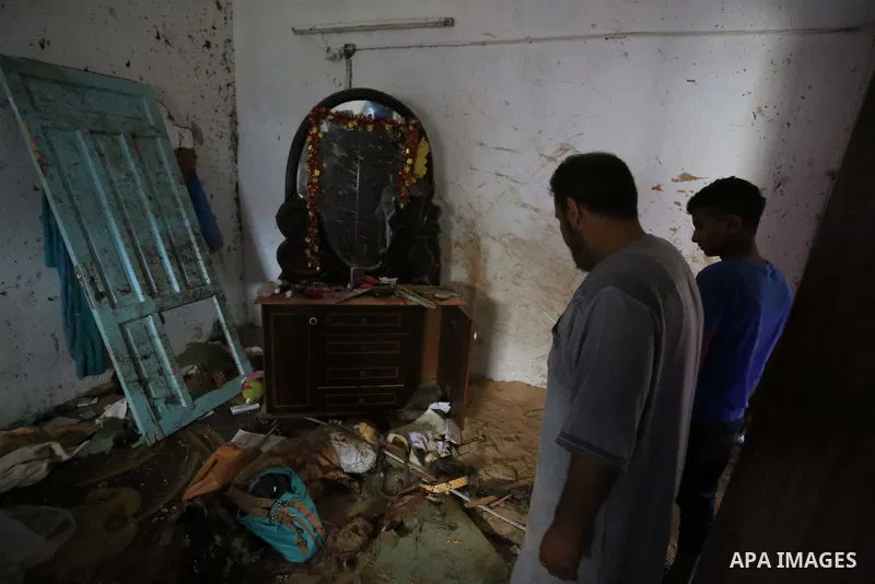 Palestinians inspect a house that was damaged in an Israeli airstrike on Dair al Balah in the center of Gaza Strip on August 9, 2018. Photo by Ashraf Amra