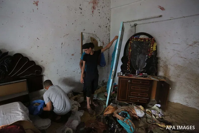 Palestinians inspect a house that was damaged in an Israeli airstrike on Dair al Balah in the center of Gaza Strip on August 9, 2018. Photo by Ashraf Amra