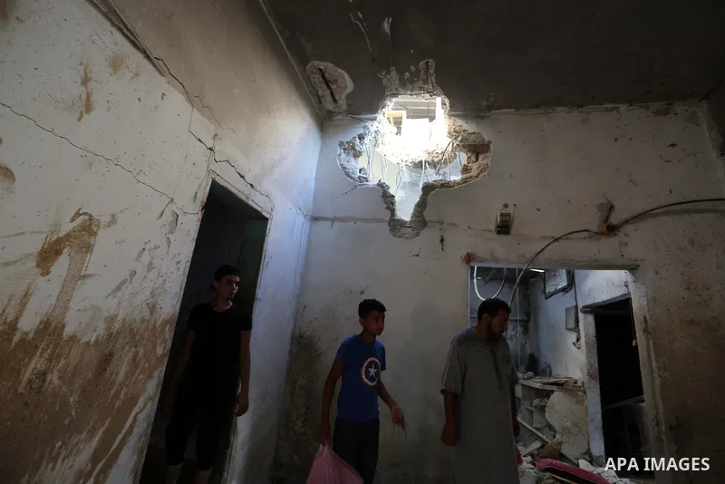 Palestinians inspect a house that was damaged in an Israeli airstrike on Dair al Balah in the center of Gaza Strip on August 9, 2018. Photo by Ashraf Amra