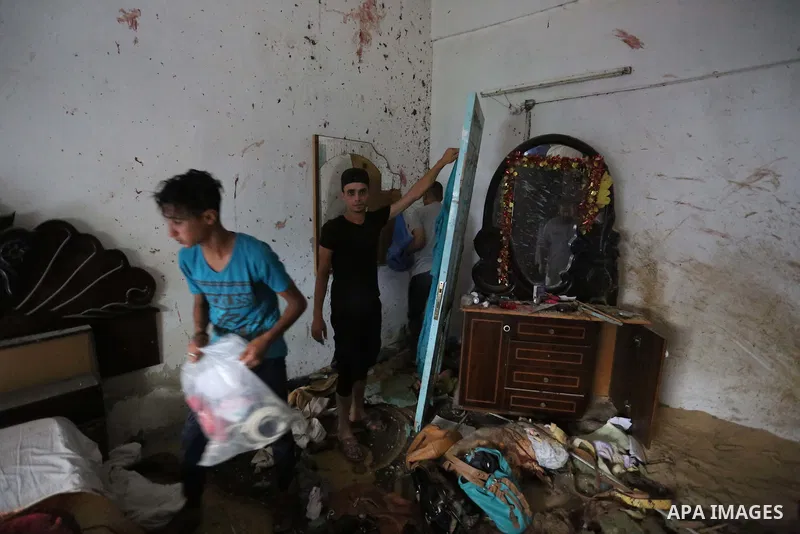 Palestinians inspect a house that was damaged in an Israeli airstrike on Dair al Balah in the center of Gaza Strip on August 9, 2018. Photo by Ashraf Amra