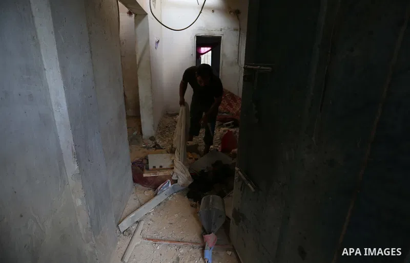 Palestinians inspect a house that was damaged in an Israeli airstrike on Dair al Balah in the center of Gaza Strip on August 9, 2018. Photo by Ashraf Amra