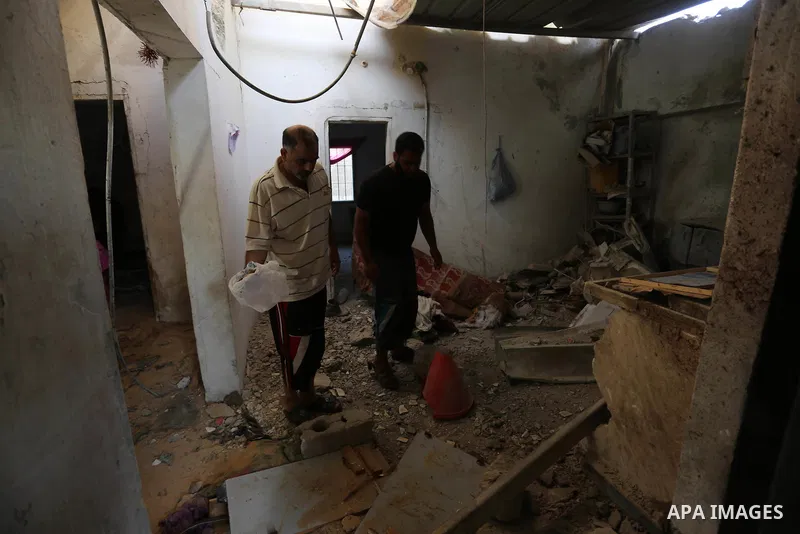 Palestinians inspect a house that was damaged in an Israeli airstrike on Dair al Balah in the center of Gaza Strip on August 9, 2018. Photo by Ashraf Amra