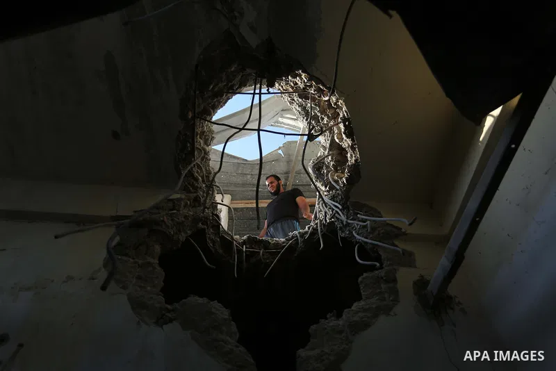Palestinians inspect a house that was damaged in an Israeli airstrike on Dair al Balah in the center of Gaza Strip on August 9, 2018. Photo by Ashraf Amra