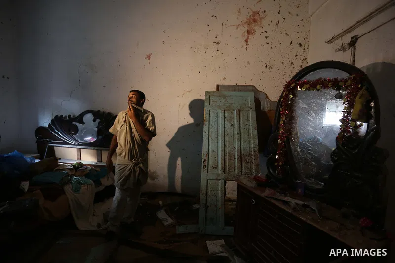 Palestinians inspect a house that was damaged in an Israeli airstrike on Dair al Balah in the center of Gaza Strip on August 9, 2018. Photo by Ashraf Amra