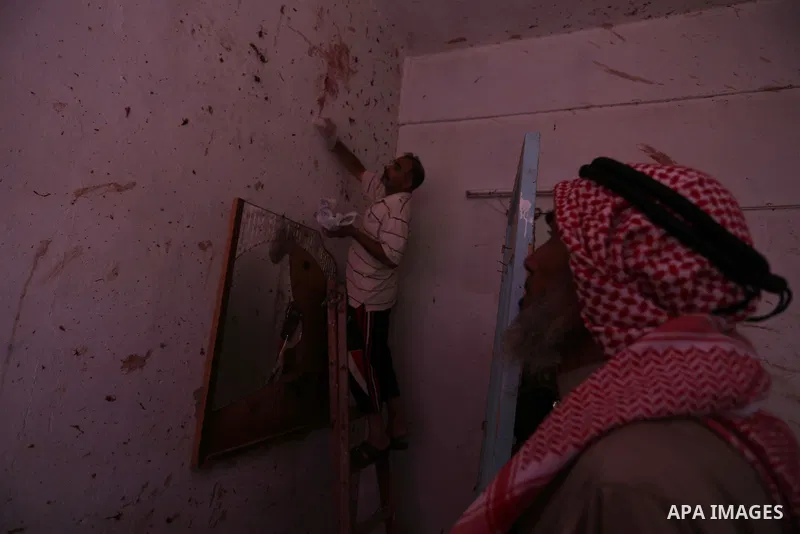 Palestinians inspect a house that was damaged in an Israeli airstrike on Dair al Balah in the center of Gaza Strip on August 9, 2018. Photo by Ashraf Amra