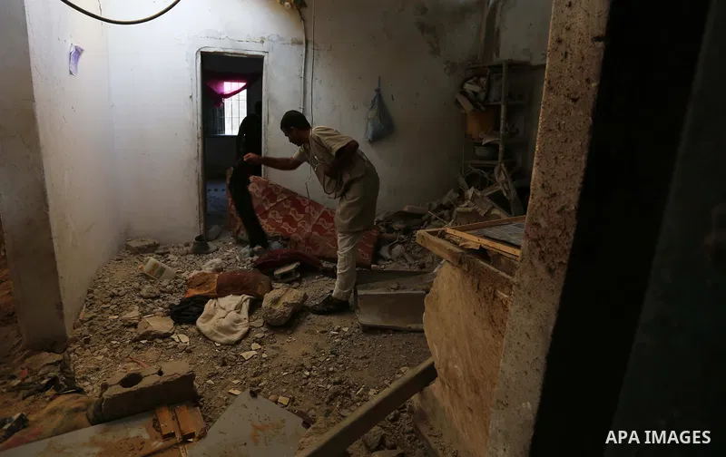 Palestinians inspect a house that was damaged in an Israeli airstrike on Dair al Balah in the center of Gaza Strip on August 9, 2018. Photo by Ashraf Amra