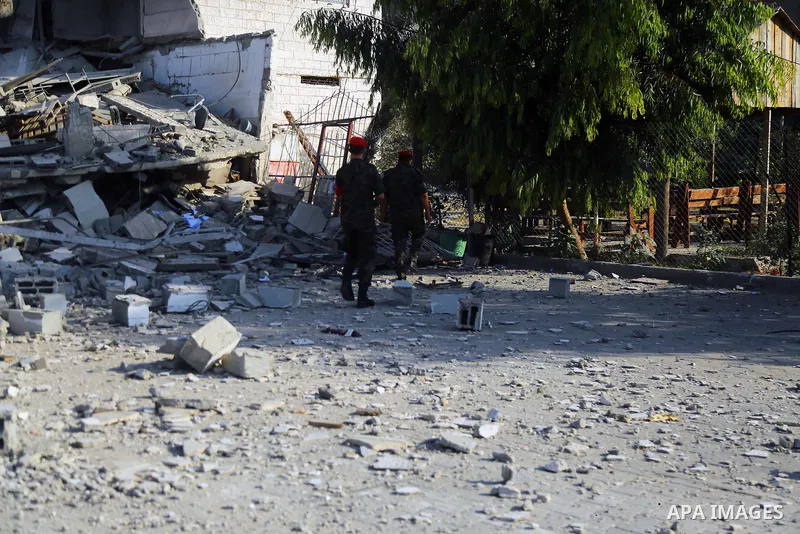 Palestinian Members of Hamas' military police inspect a site damaged in an Israeli airstrike in Gaza City on August 9, 2018. Photo by Dawoud Abo Alkas