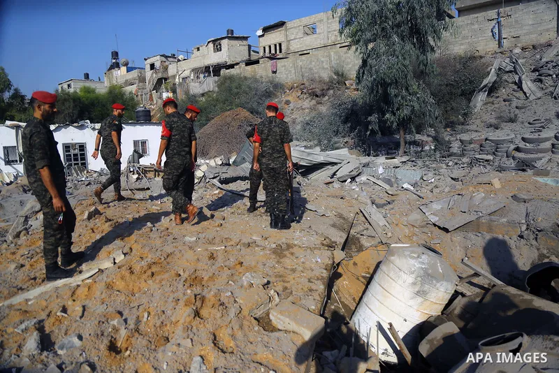 Palestinian Members of Hamas' military police inspect a site damaged in an Israeli airstrike in Gaza City on August 9, 2018. Photo by Dawoud Abo Alkas