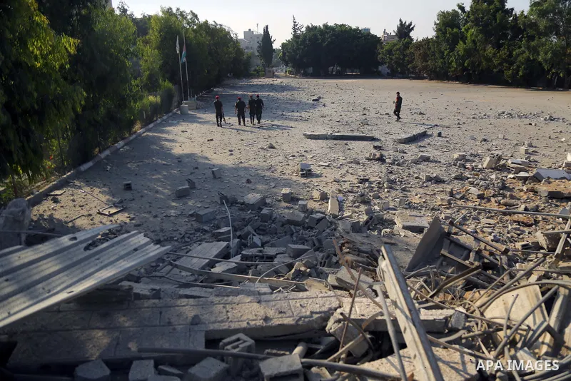 Palestinian Members of Hamas' military police inspect a site damaged in an Israeli airstrike in Gaza City on August 9, 2018. Photo by Dawoud Abo Alkas