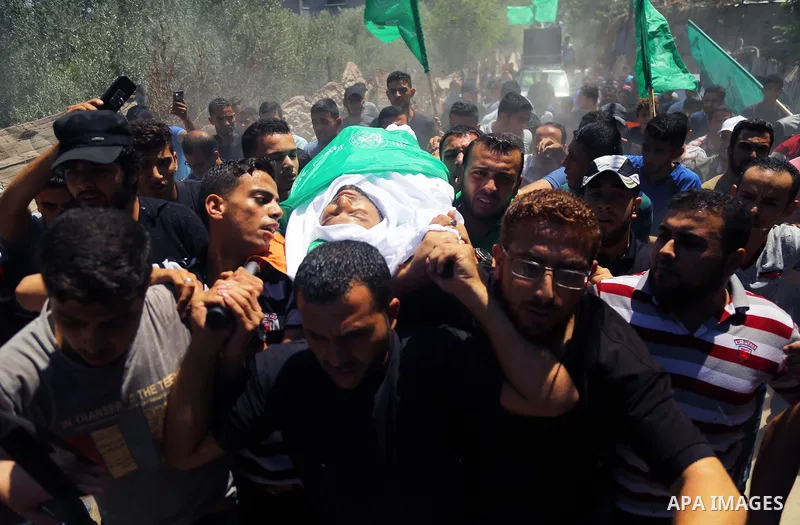 Mourners carry the body of Palestinian Hamas militant Ali al-Ghandour who was killed in an Israeli airstrike, during his funeral in the northern of Gaza Strip on August 9, 2018. Photo by Dawoud Abo Alkas