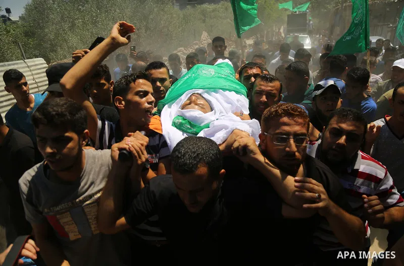 Mourners carry the body of Palestinian Hamas militant Ali al-Ghandour who was killed in an Israeli airstrike, during his funeral in the northern of Gaza Strip on August 9, 2018. Photo by Dawoud Abo Alkas