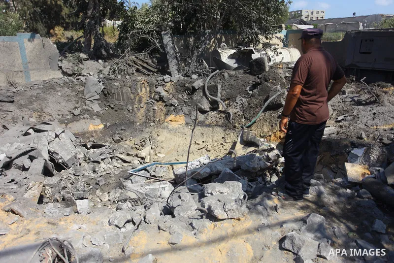 Palestinians inspect a site that was damaged in an Israeli airstrike in Beit Lahia, in the northern of Gaza Strip on August 9, 2018. Photo by Mahmoud Ajour