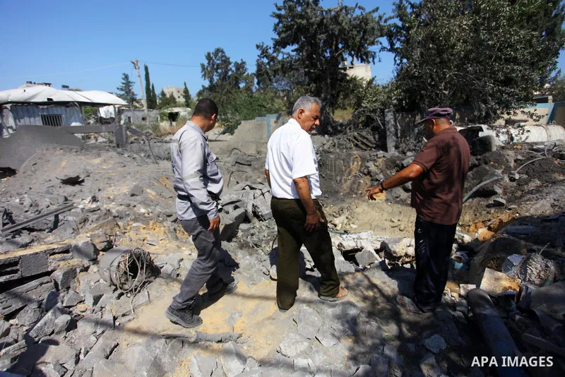 Palestinians inspect a site that was damaged in an Israeli airstrike in Beit Lahia, in the northern of Gaza Strip on August 9, 2018. Photo by Mahmoud Ajour