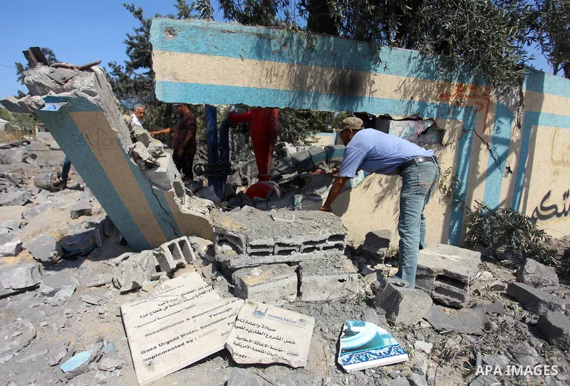 Palestinians inspect a site that was damaged in an Israeli airstrike in Beit Lahia, in the northern of Gaza Strip on August 9, 2018. Photo by Mahmoud Ajour