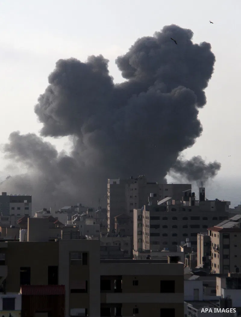 A picture taken on August 9, 2018 shows smoke plumes risisng following an Israeli air strike in Gaza City. Photo by Mahmoud Ajour