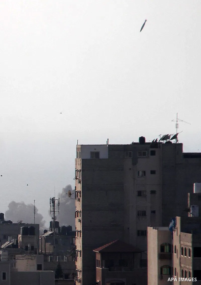 A missile lands as Israeli aircraft bombs a building in Gaza City August 9, 2018. Photo by Mahmoud Ajour