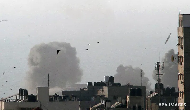 A missile lands as Israeli aircraft bombs a building in Gaza City August 9, 2018. Photo by Mahmoud Ajour