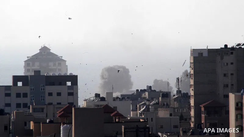 A missile lands as Israeli aircraft bombs a building in Gaza City August 9, 2018. Photo by Mahmoud Ajour