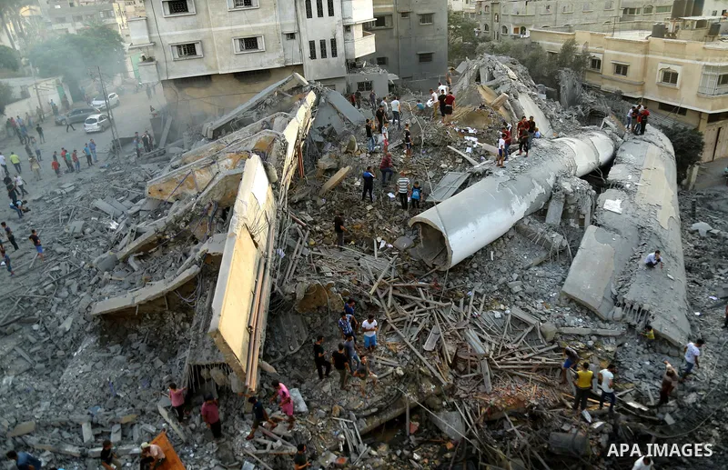 Palestinians inspect the rubble of a building following an Israeli air strike on Gaza City, on August 9, 2018. Photo by Dawoud Abo Alkas