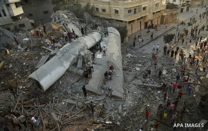 Palestinians inspect the rubble of a building following an Israeli air strike on Gaza City, on August 9, 2018. Photo by Dawoud Abo Alkas